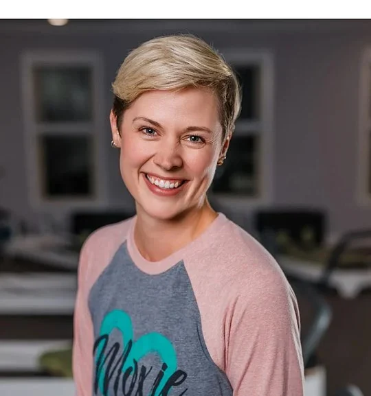 Portrait of Brittany Mora smiling in a studio