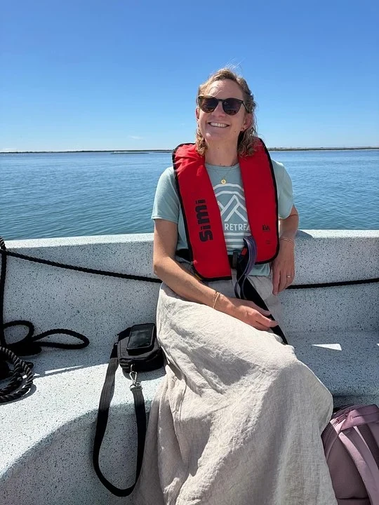 Lindsay Eldridge, founder of Away Retreats, smiling in a life jacket on a boat trip