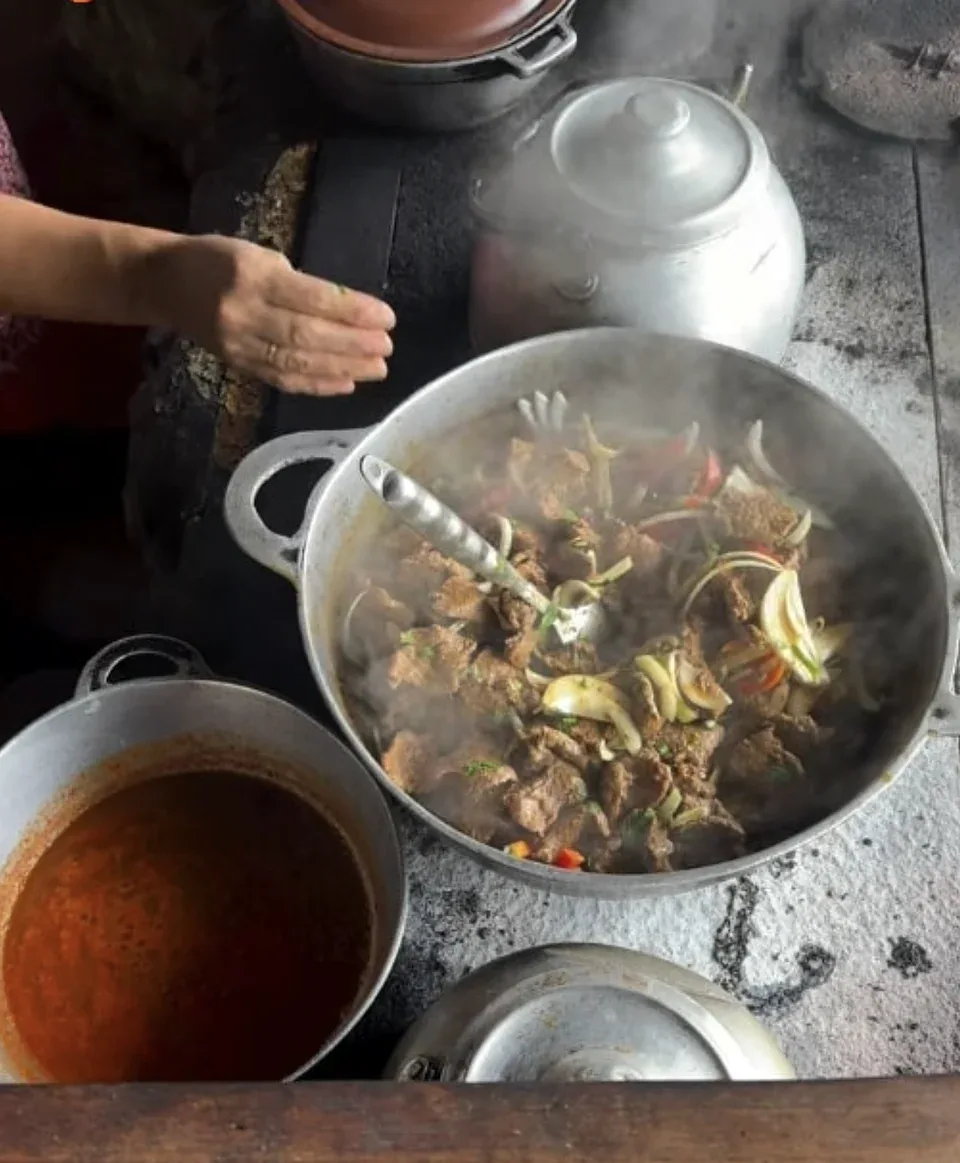 Local cook preparing a farm-to-table meal on a wood stove in Costa Rica