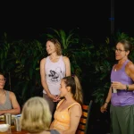 Away Retreats group gathered and laughing at dinner at night in Costa Rica