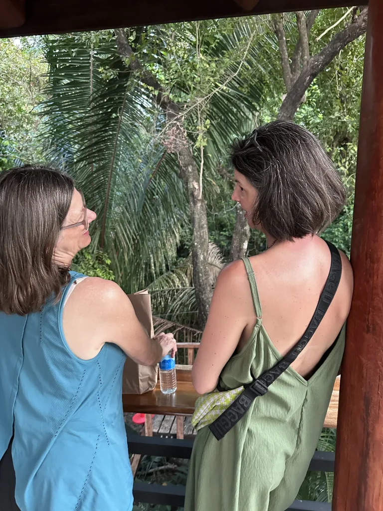 Two guests chatting on a jungle-view deck during the Real Costa Rica retreat