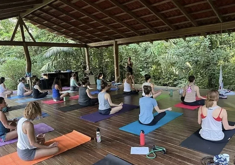 Open-air morning class on a jungle deck during a Pilates retreat in Costa Rica