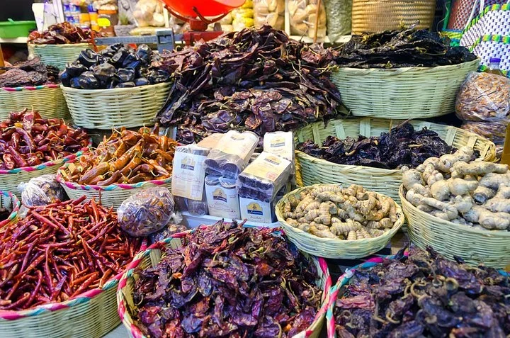 Woven baskets filled with dried chiles and other spices at a Mexican market